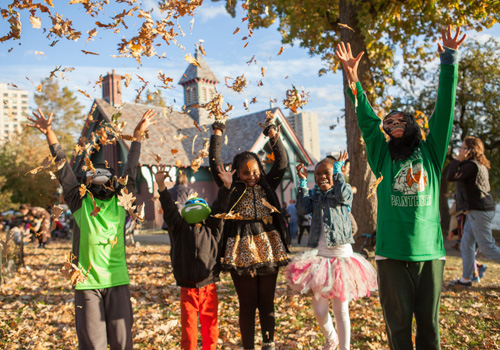 Kids tossing leaves