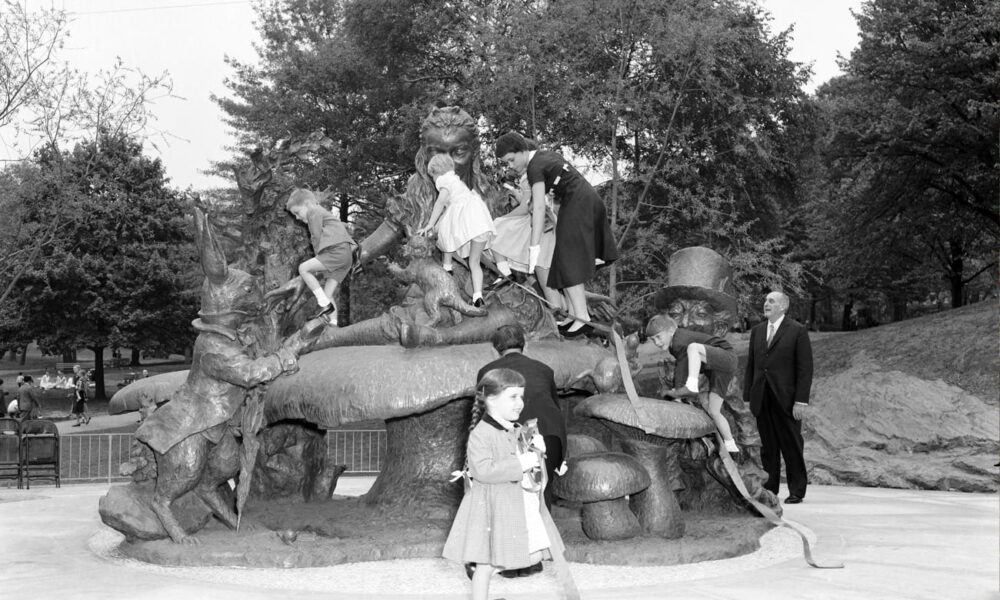 Historical photo of kids climbing on the Alice in Wonderland statue