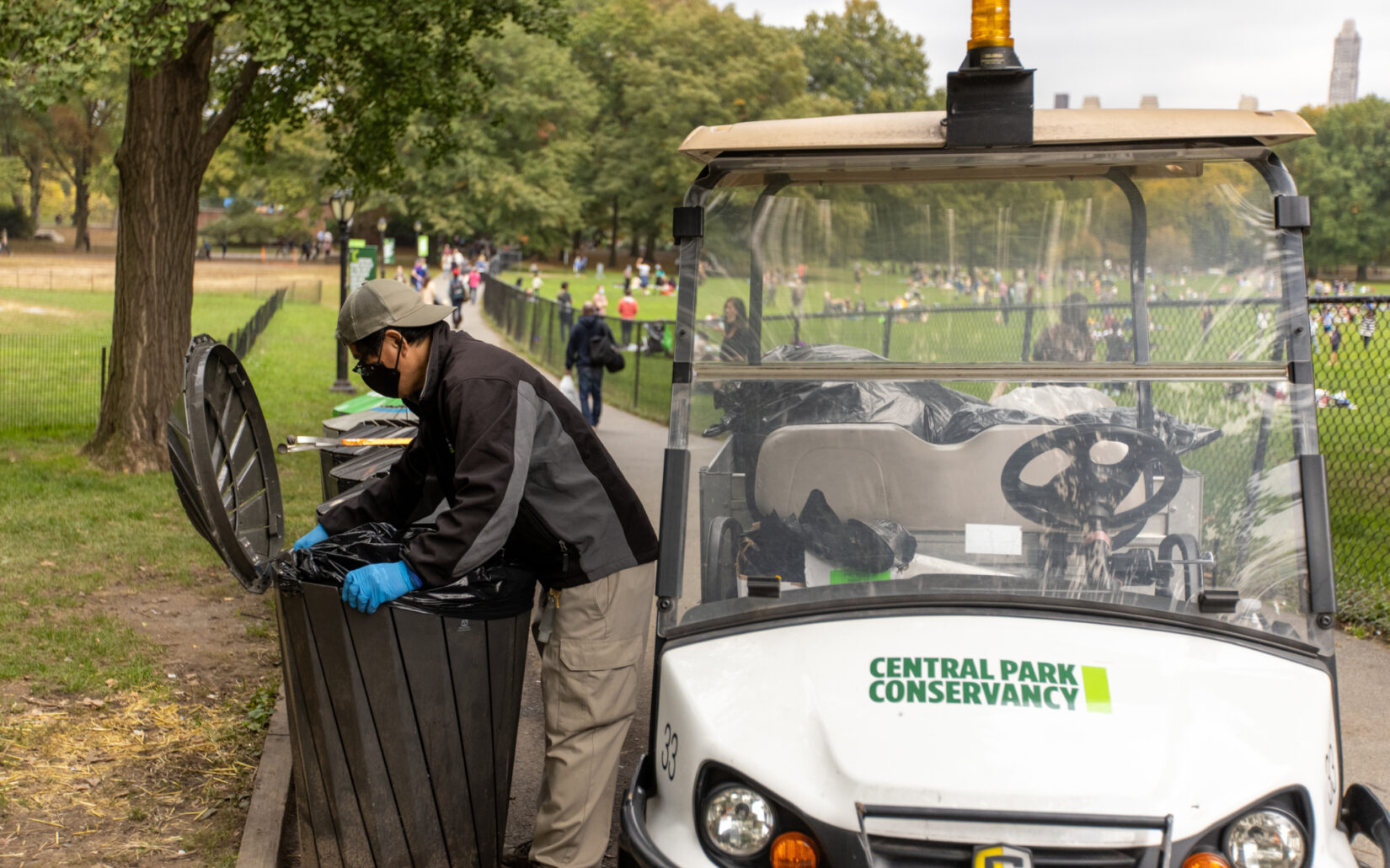 Staff member Danilo Maturan uses an electric cart as part of his trash maintenance routine.