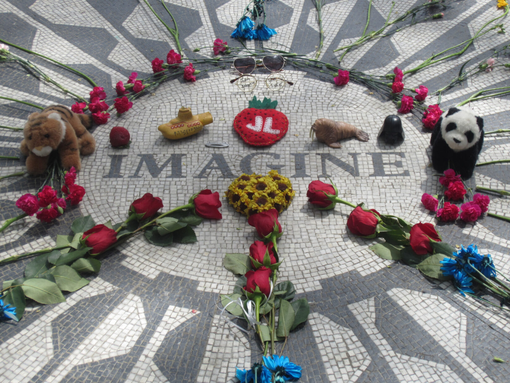 Flowers left at the Imagine mosaic at Strawberry Fields
