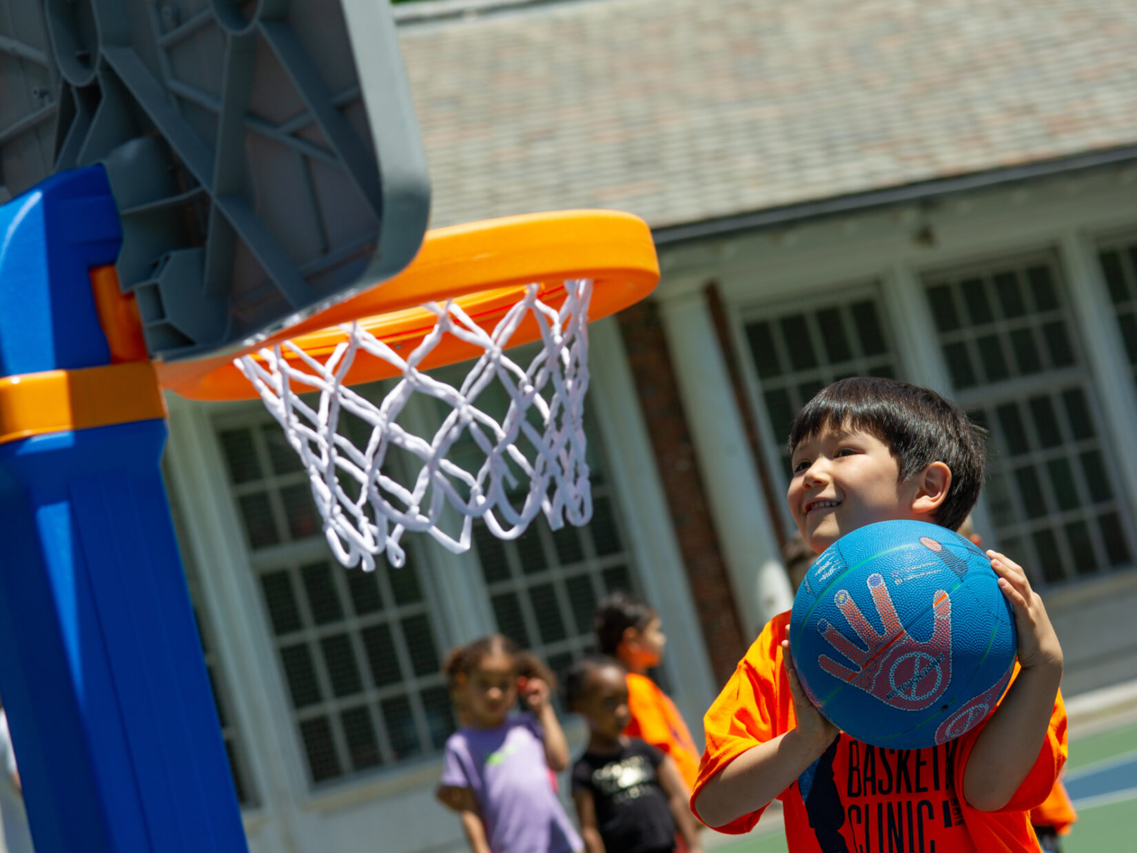 A young hoopster aiming for a toddler-appropriate basket