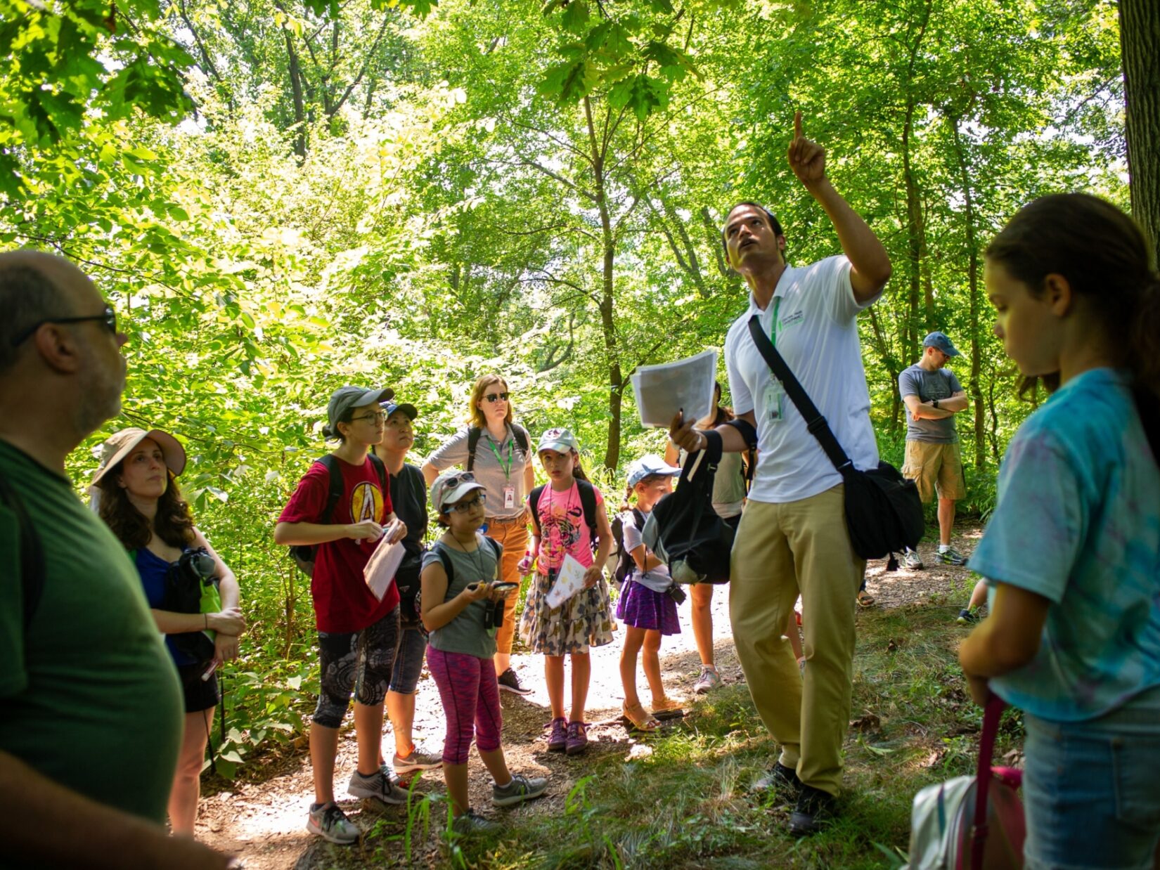 Kids and tour-goers in rapt attention to a tour guide in the North Woods