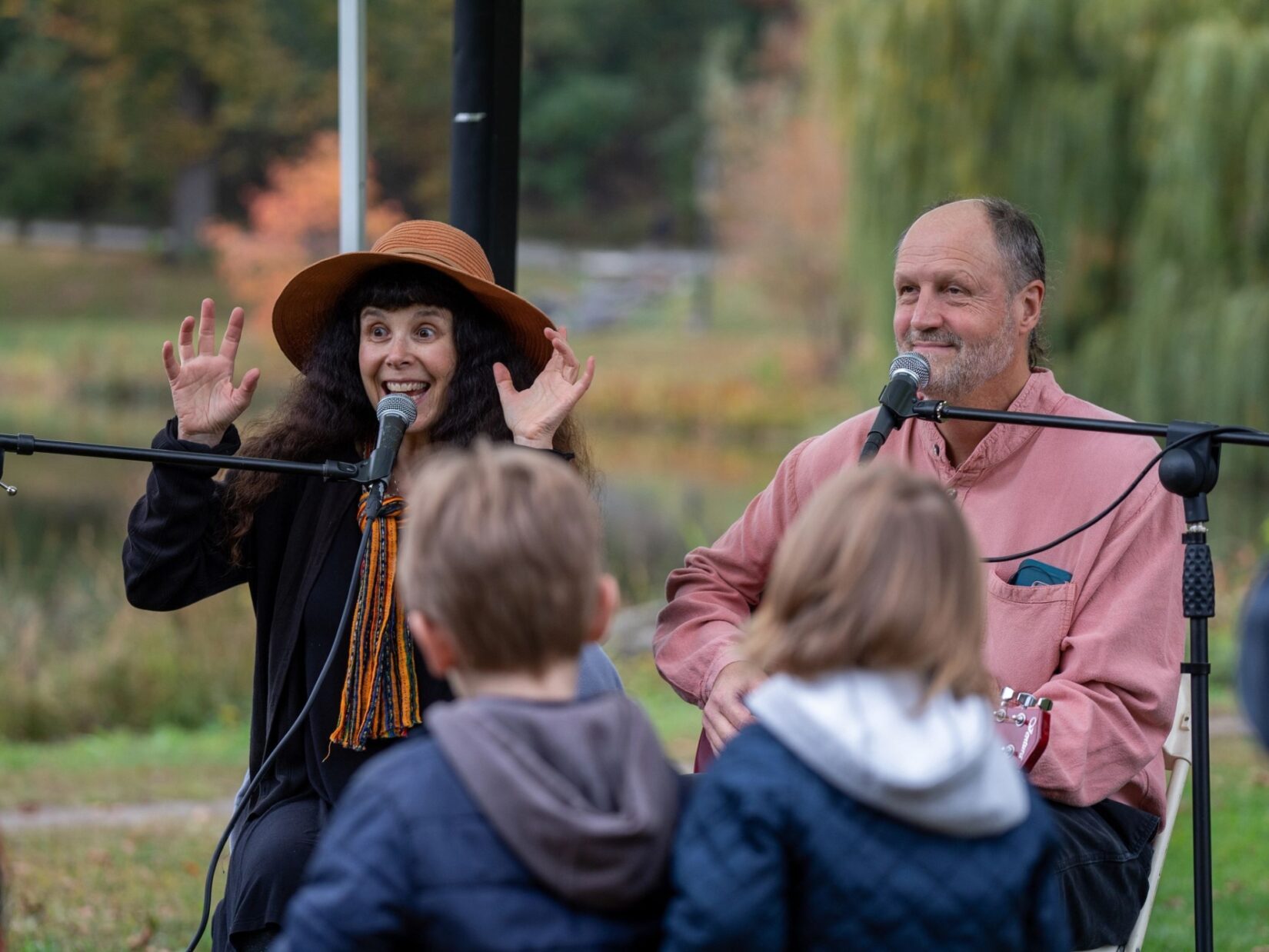 A man and a woman, neither particularly spooky, entertain the crowd with Halloween songs.