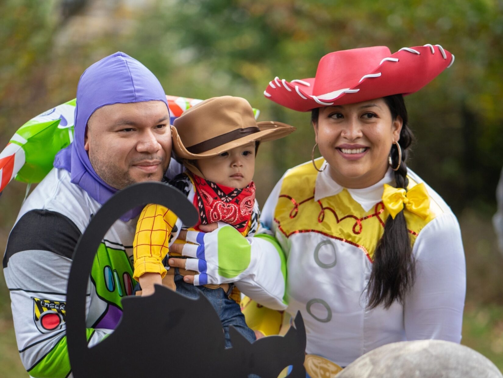 A young family pose in their coordinated Toy Story costumes