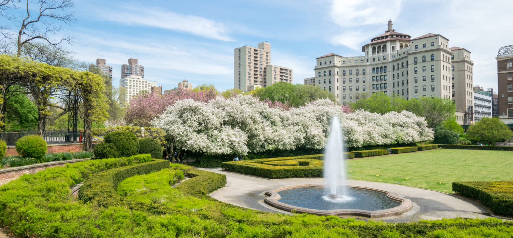 A sweeping view of Conservatory Garden in Spring, taking in the fountain and the pergola