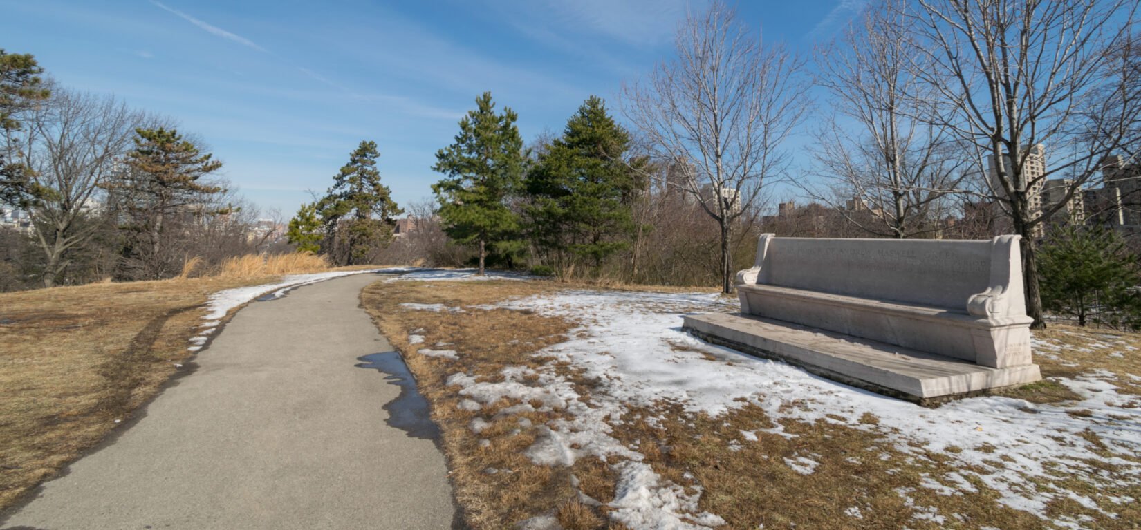 The landscape of Fort Fish shows a path winding toward a stand of trees