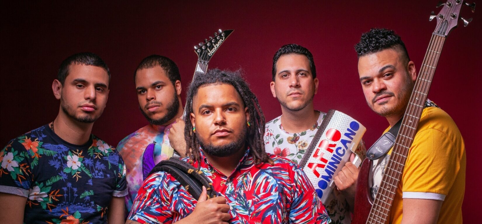 Members of the band pictured with their instruments against a red backdrop.