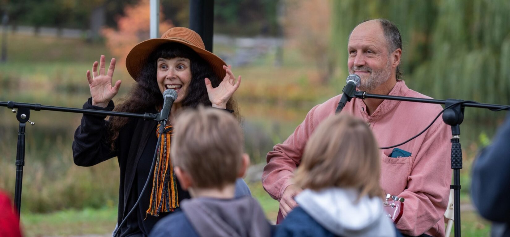 A man and a woman, neither particularly spooky, entertain the crowd with Halloween songs.