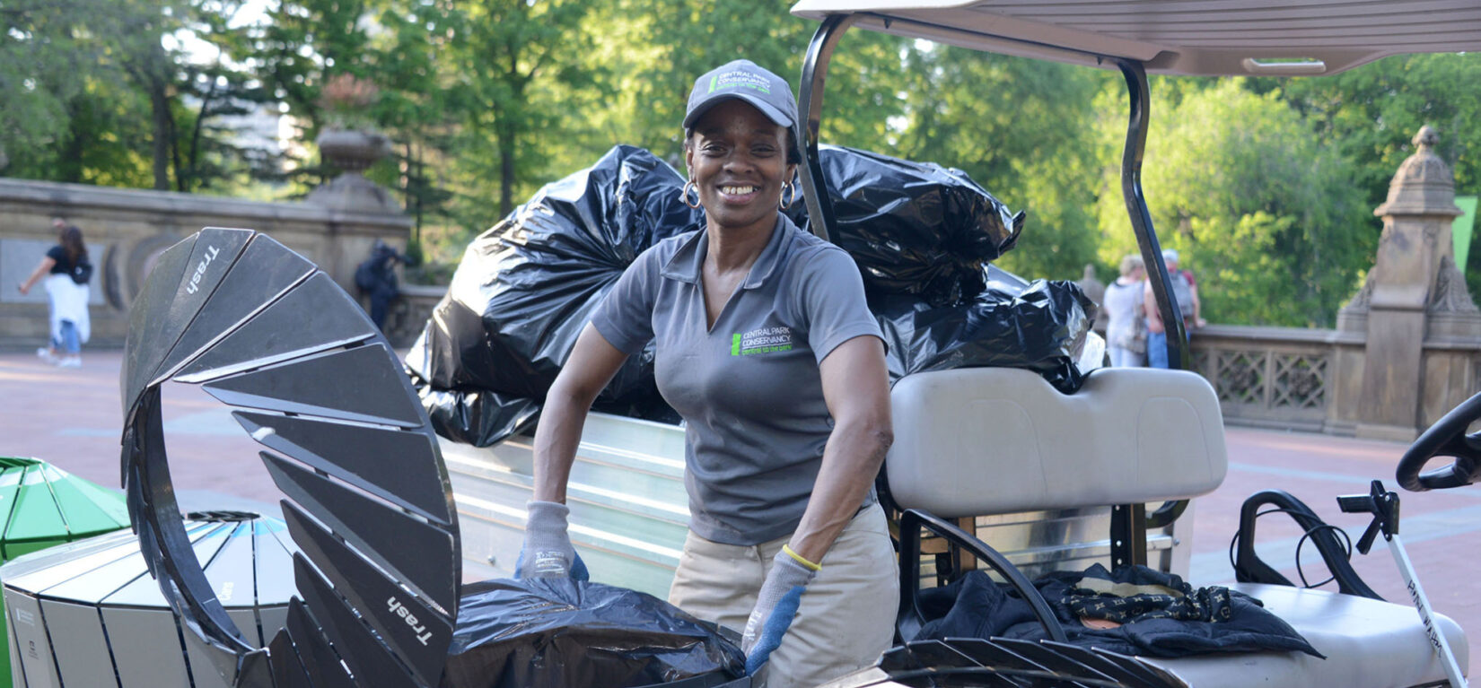 A member of the Conservancy staff emptying trash bins