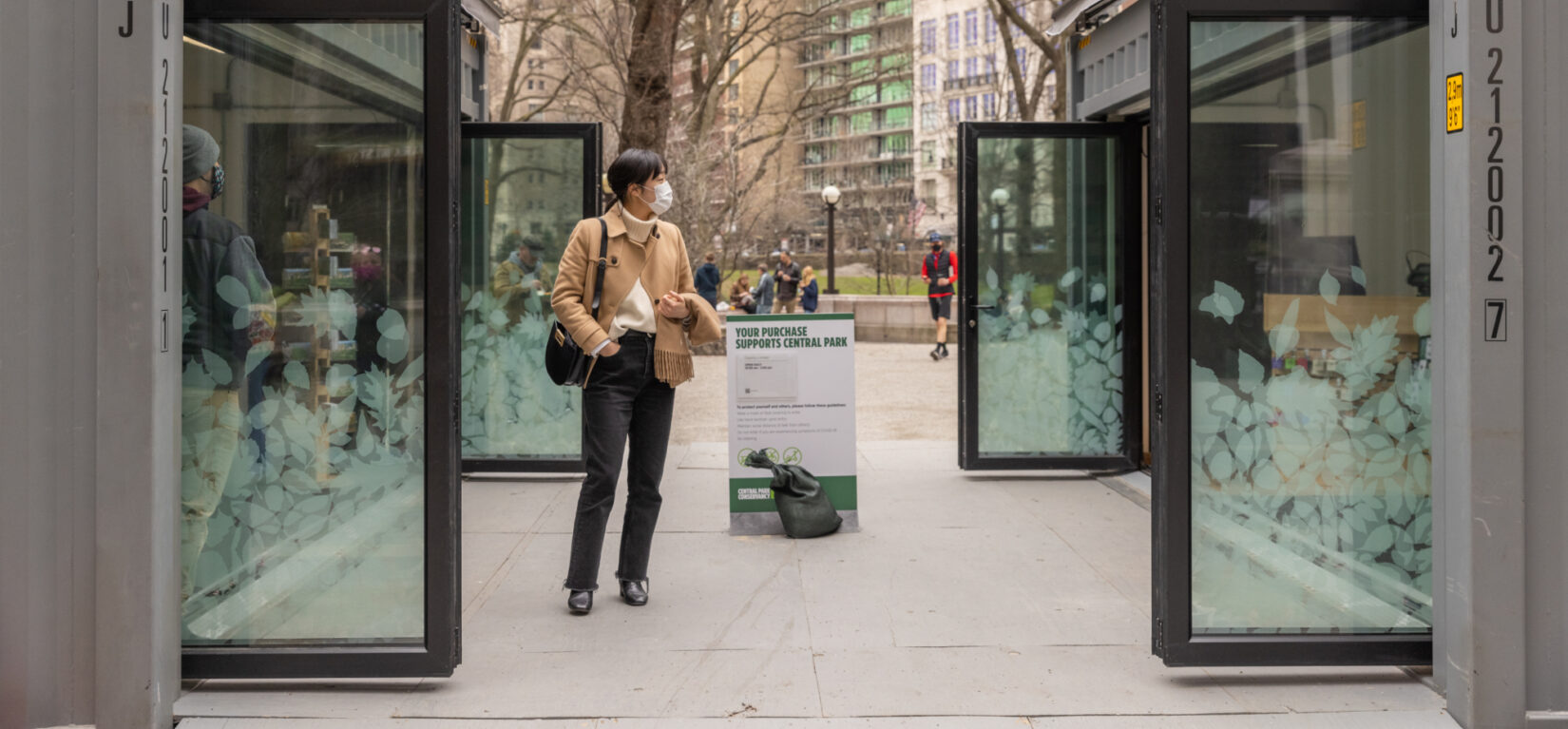 A visitor window-shops between the two units that comprise the pop-up shop.