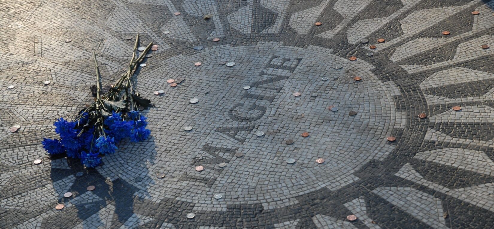 A clutch of flowers is left in tribute at the Imagine mosaic