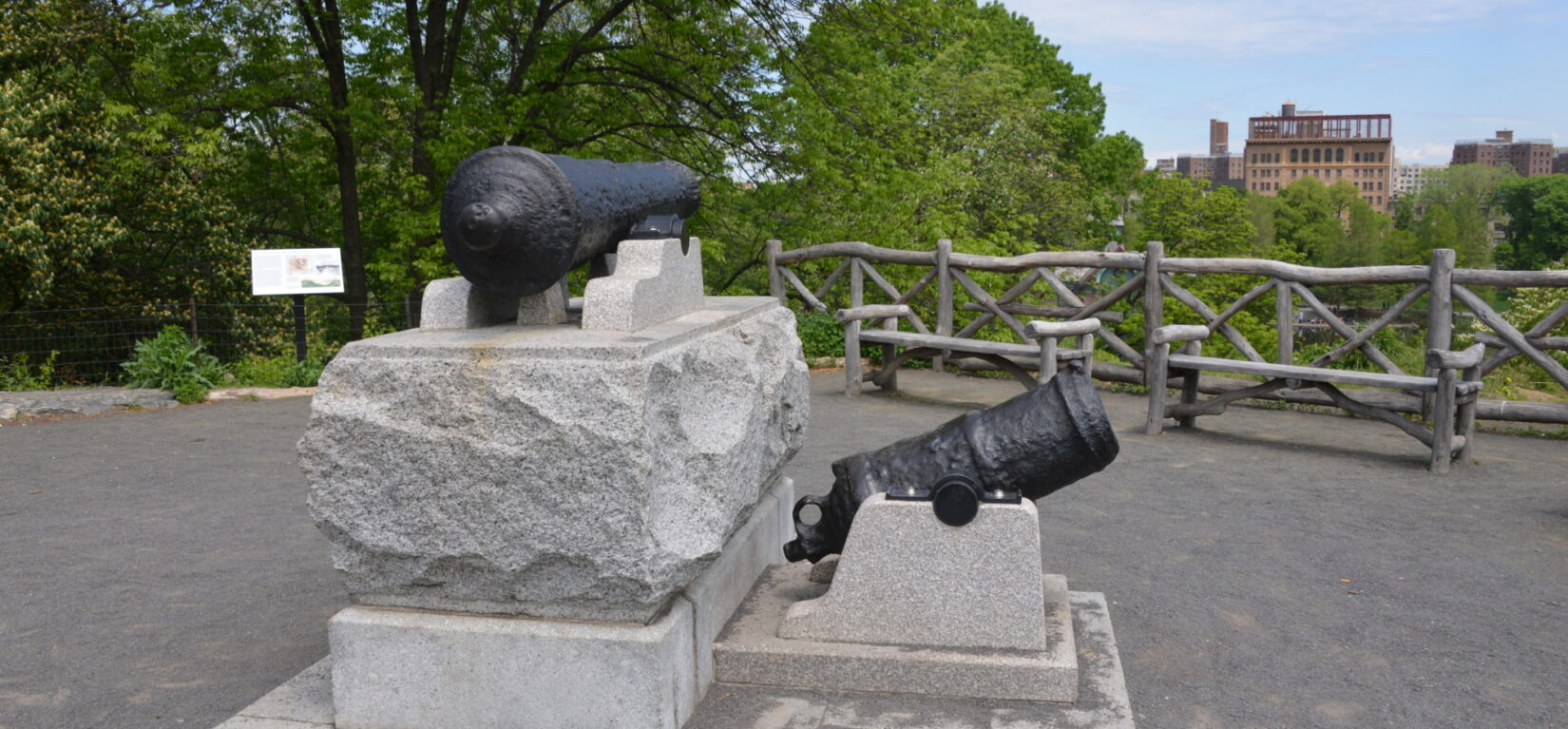Two antique canons on rough-hewn stone foundations commemorate the Fort Clinton landscape.