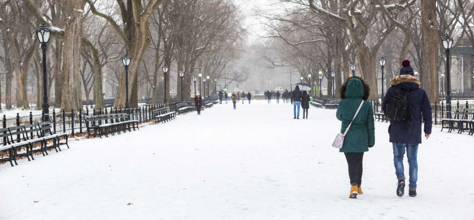 A couple walk down the Mall after a snowfall