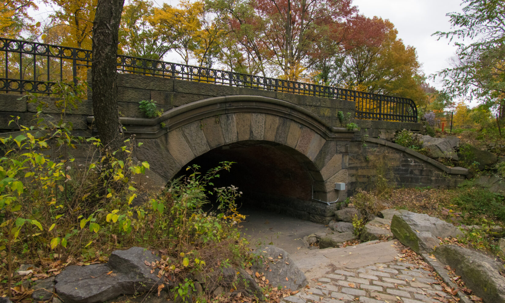 A brick path leads down to the mouth of the arch.