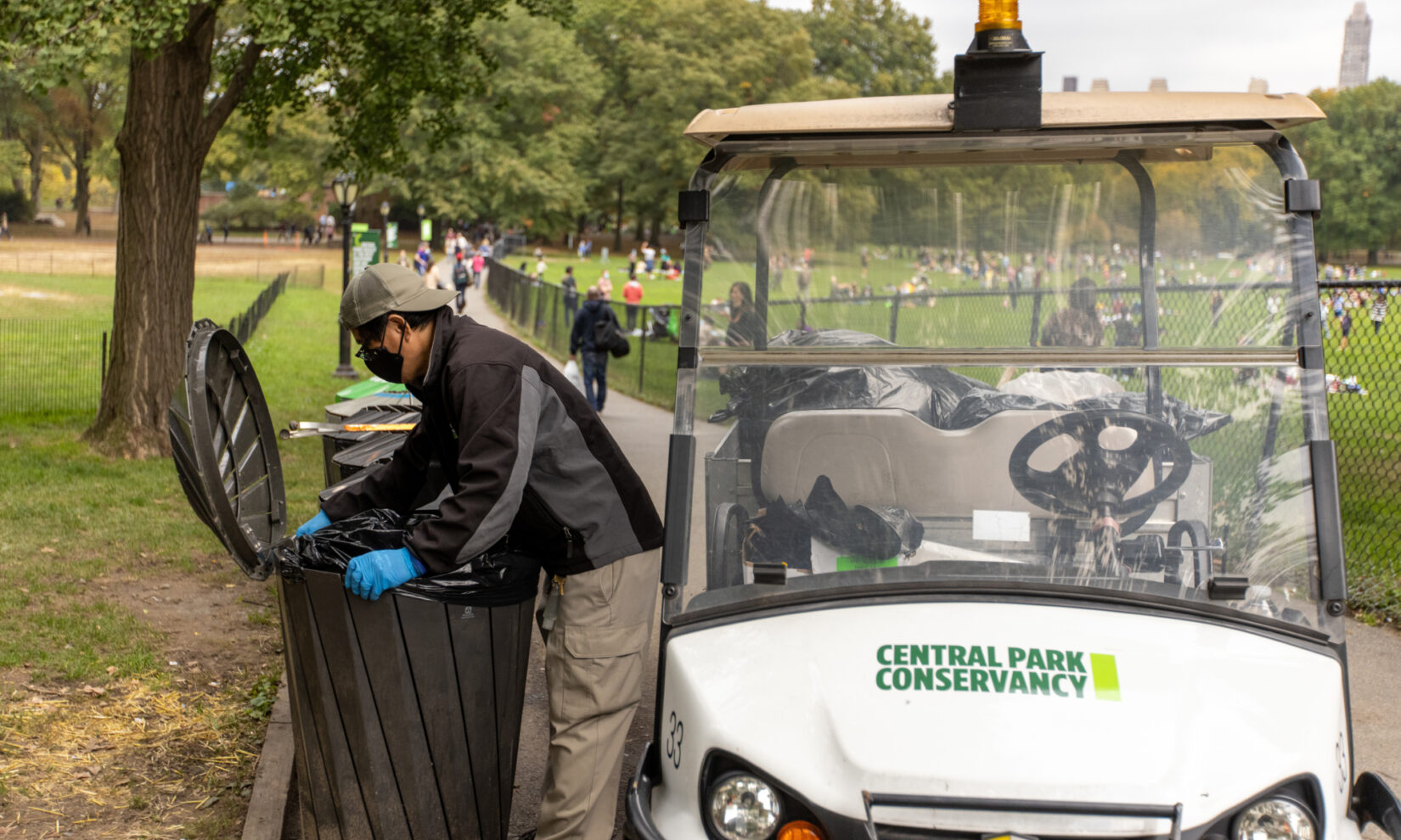 Staff member Danilo Maturan uses an electric cart as part of his trash maintenance routine.