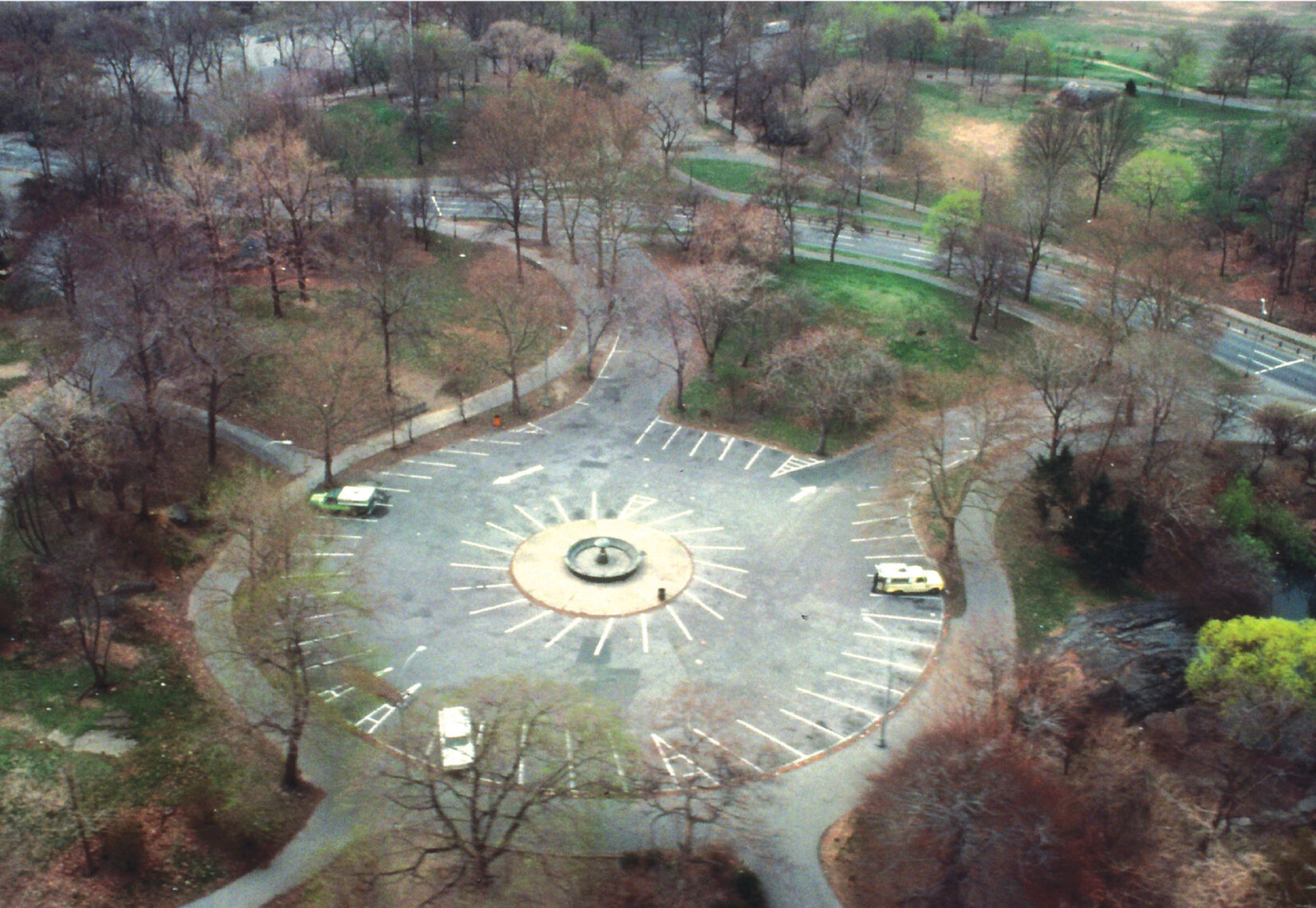 Aerial view showing parking spaces and a few parked cars.