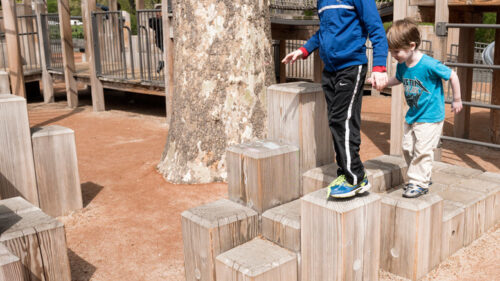 Kids balancing on wooden perches