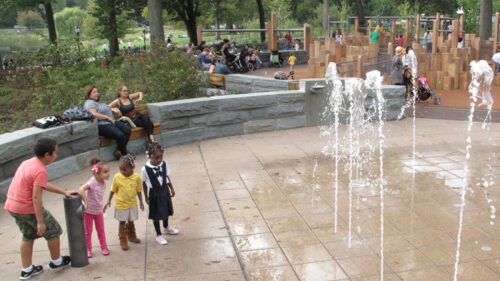Kids cautiously approaching the water feature