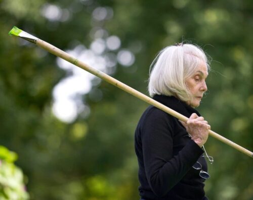 The artist with one of the very long brushes required by her working method