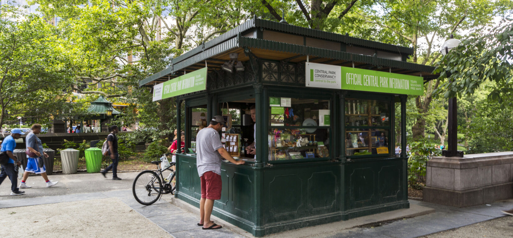 A patron at the kiosk, its windows open to a summer day