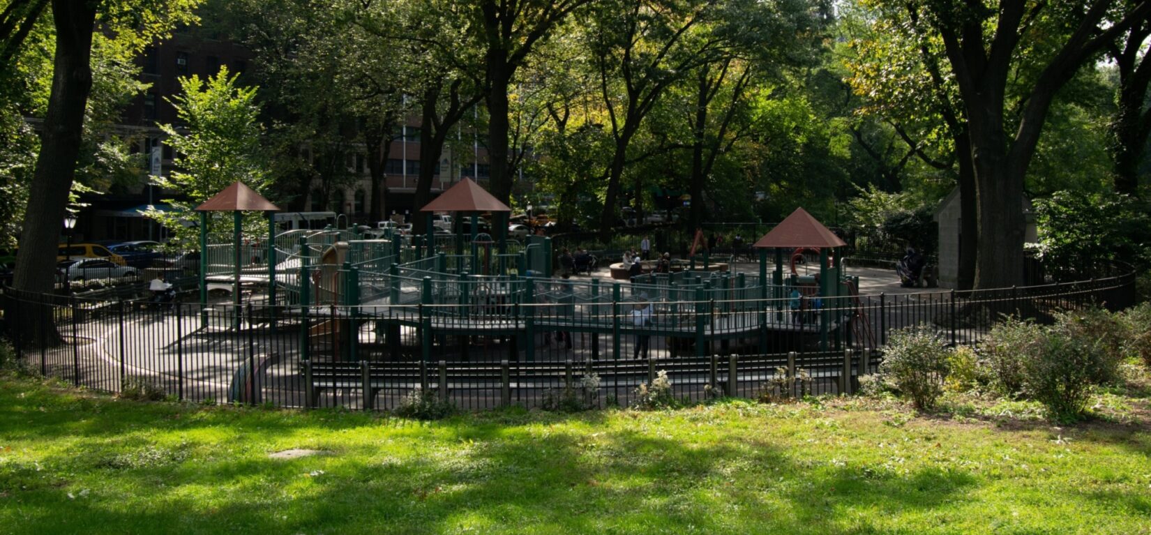 A view of the playground from afar, highlighting the green surroundings